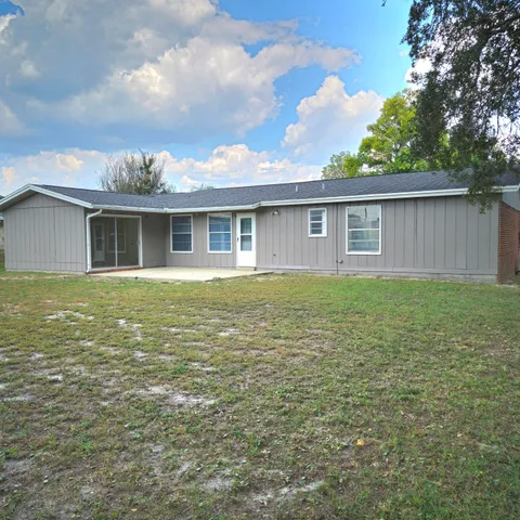 a view of house with yard outdoor seating and barbeque oven