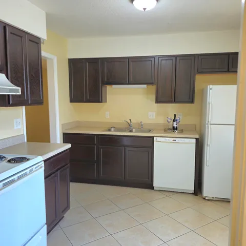a kitchen with a sink and a refrigerator
