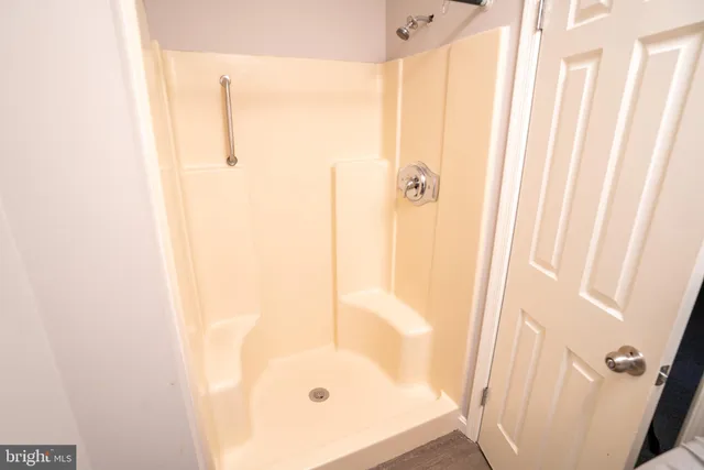 an empty room with windows and closet