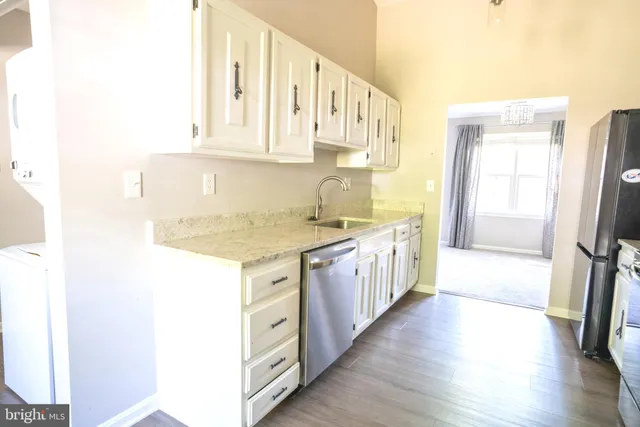 a large kitchen with a wooden floor and a sink