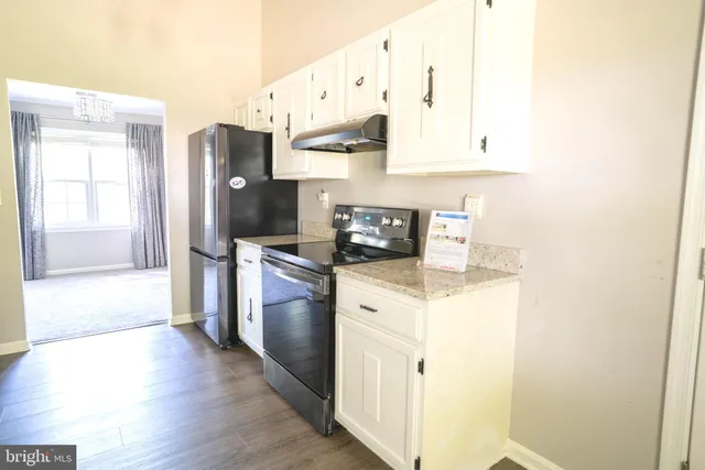 a hallway with windows and chandelier