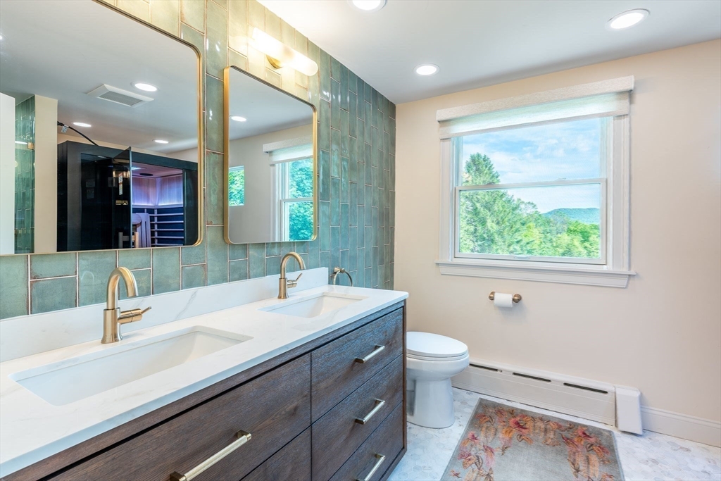 585 Station Road Amherst, MA 01002 - Photo 27 of 42 a bathroom with a double vanity sink toilet and a mirror