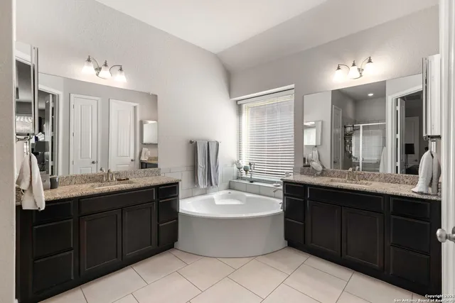 a large bathroom with a double vanity sink mirror and double