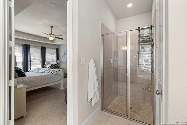 a en suite bathroom with a shower and a sink