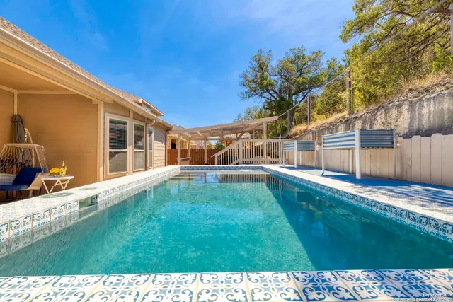 a view of a patio with table and chairs with wooden fence and floor