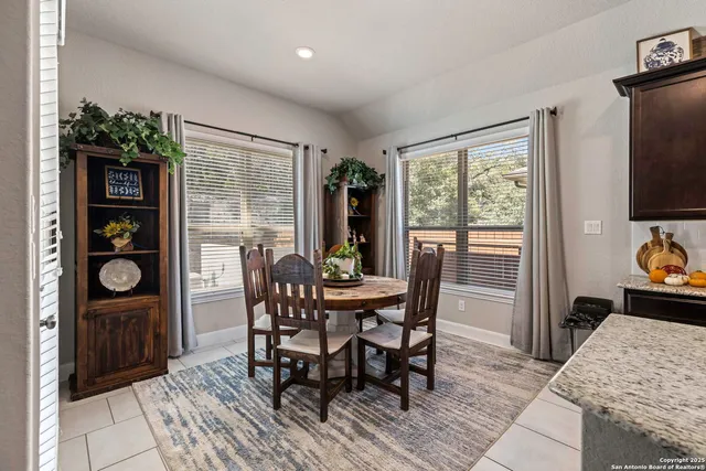 a view of a dining room with furniture and a window