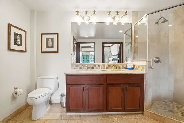 a bathroom with a double vanity sink mirror and shower