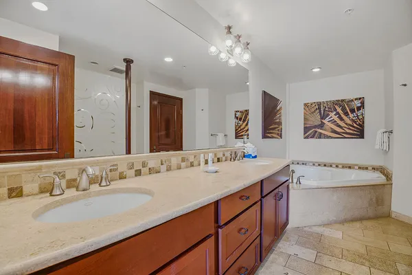 a bathroom with a sink a mirror and a vanity