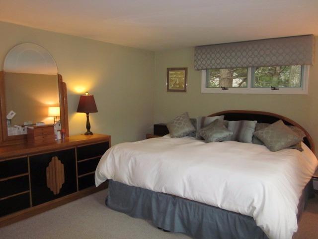 110 Guildford Road Centerville, MA 02632 - Photo 14 of 25 a bedroom with a bed and a mirror