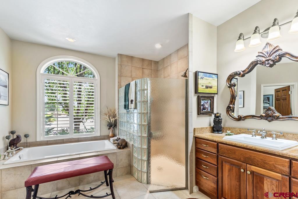 15103 6260th Road Montrose, CO 81403 - Photo 23 of 45 a spacious bathroom with a granite countertop tub sink and mirror