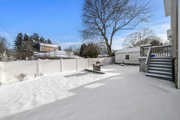 a view of a house with snow in front of it