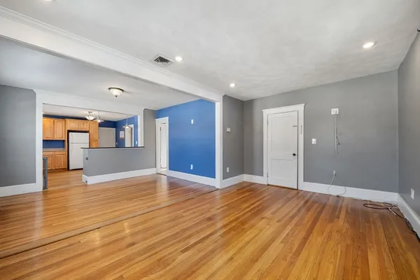 a view of an empty room and wooden floor