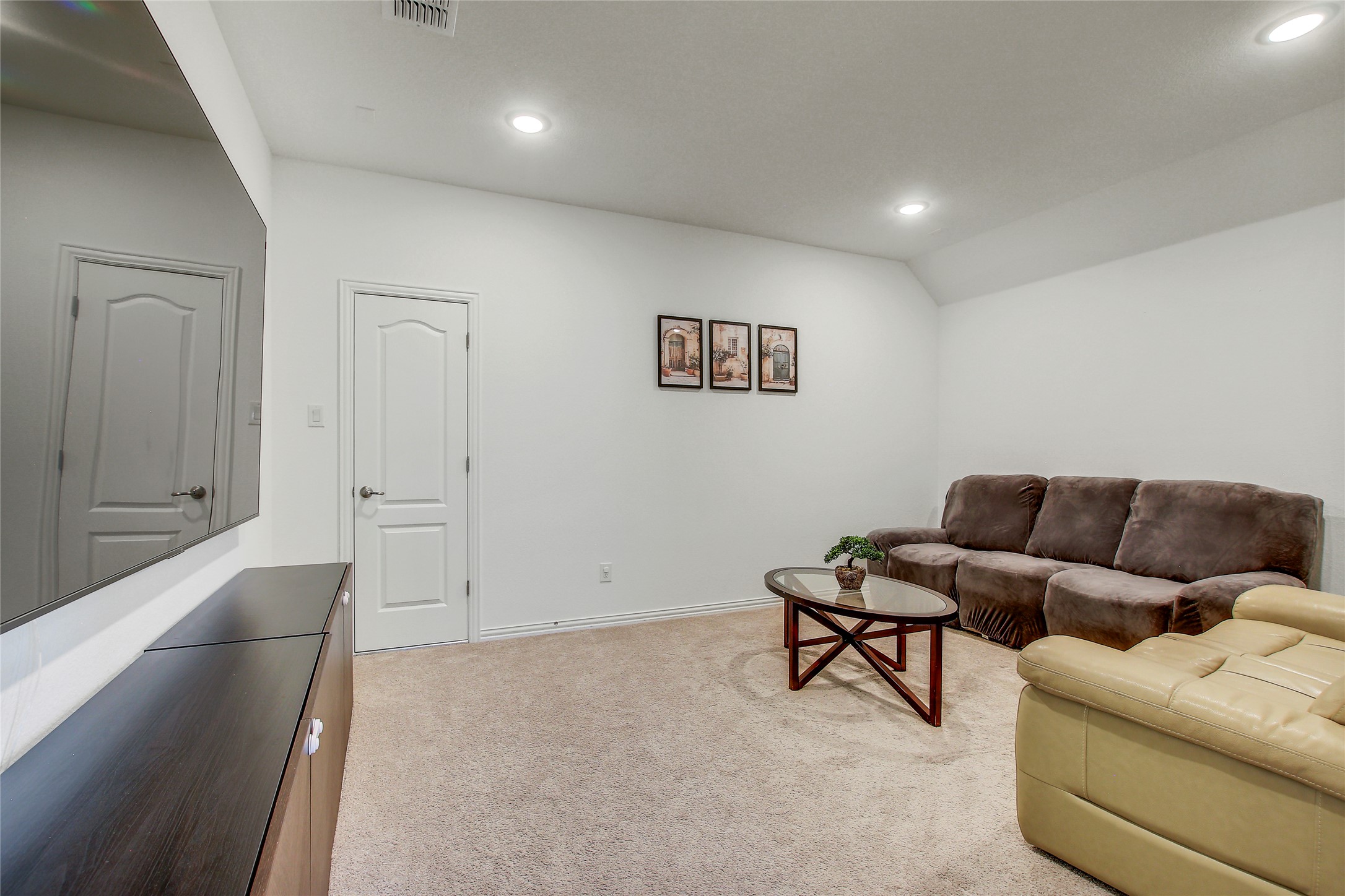 104 Millbend Road Georgetown, TX 78633 - Photo 30 of 40 Recessed lighting illuminates a versatile interior space, offering comfortable living with plush carpeting.