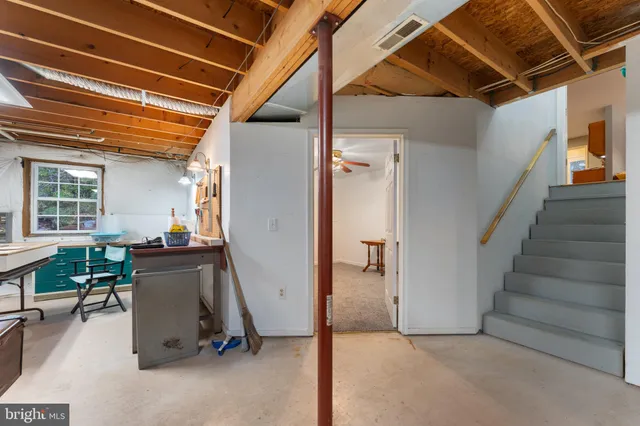a room with furniture pool table and a window