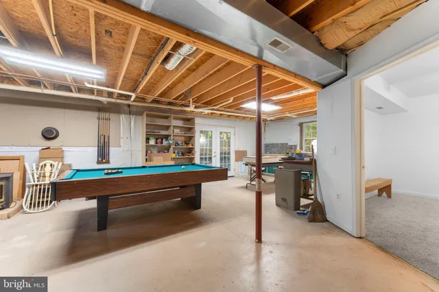 a room with pool table and furniture