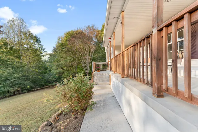 a view of a terrace with yard and mountain view in the background