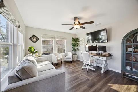 a living room with furniture a fireplace and a flat screen tv