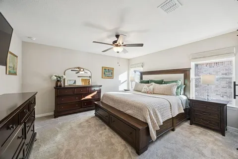 a bedroom with a bed and a ceiling fan