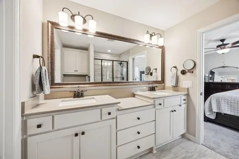 a en suite bathroom with double sink and a mirror