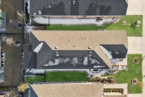 an aerial view of a house with a yard