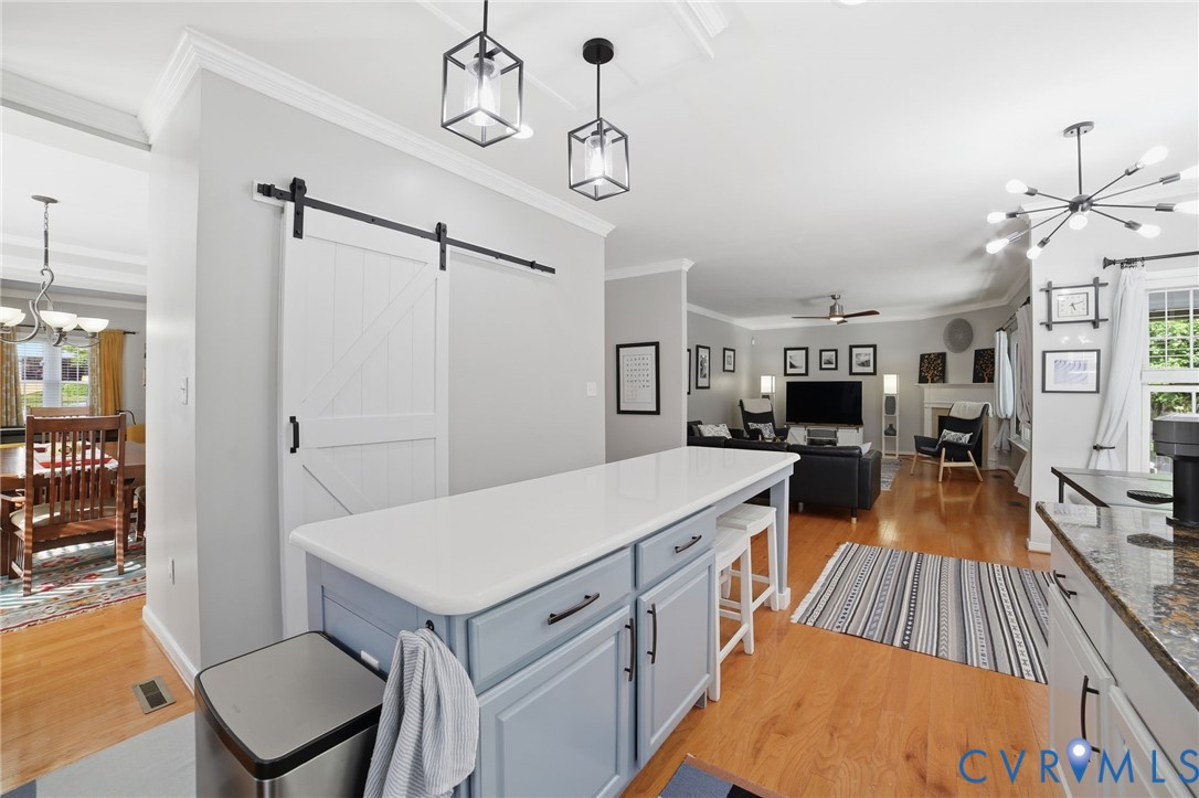 9509 Meadowview Road Henrico, VA 23294 - Photo 11 of 38 a living room with stainless steel appliances kitchen island a stove a table and chairs