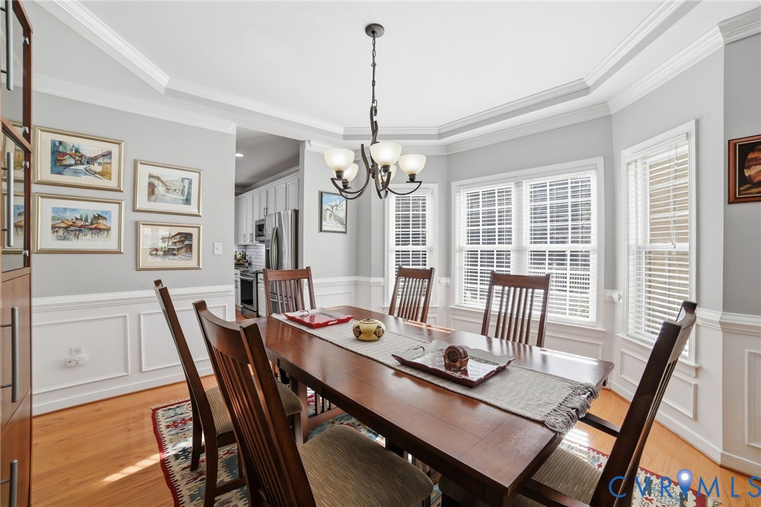 9509 Meadowview Road Henrico, VA 23294 - Photo 15 of 38 a dining room with furniture a chandelier and wooden floor