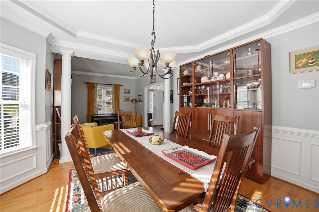 9509 Meadowview Road Henrico, VA 23294 - Photo 16 of 38 a dining room with furniture a chandelier and wooden floor