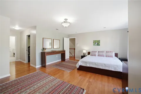 a spacious bedroom with a bed and a view of bathroom