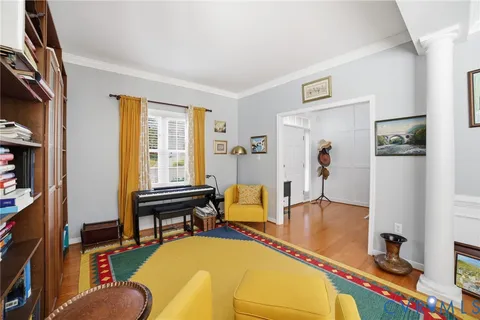 a living room with furniture fireplace and a window