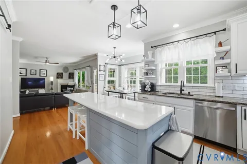 a large kitchen with a table and chairs in it