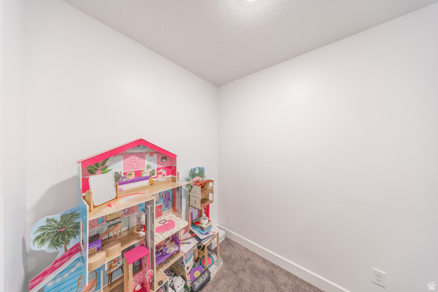 4765 Breezy Patch Road Eagle Mountain, UT 84005 - Photo 14 of 25 Neutral-toned room with white walls, textured ceiling, recessed lighting, and grey carpet flooring