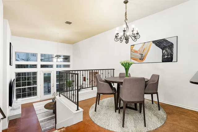 a view of a dining room with furniture wooden floor and chandelier