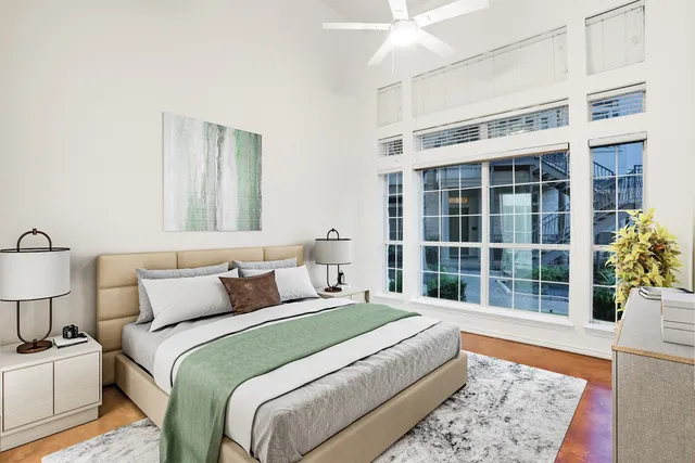 a bedroom with a large bed and a large window