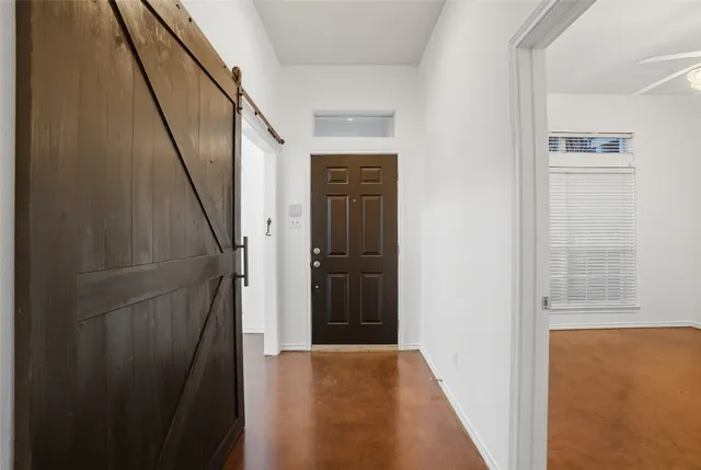 a view of a hallway with wooden floor and entryway