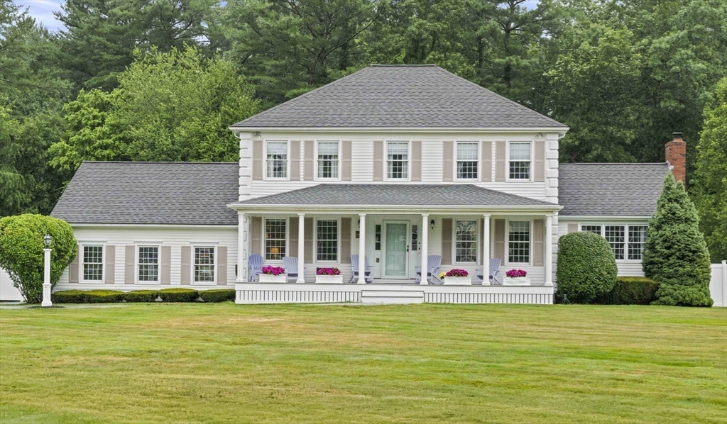 a front view of house with outdoor seating yard and green space