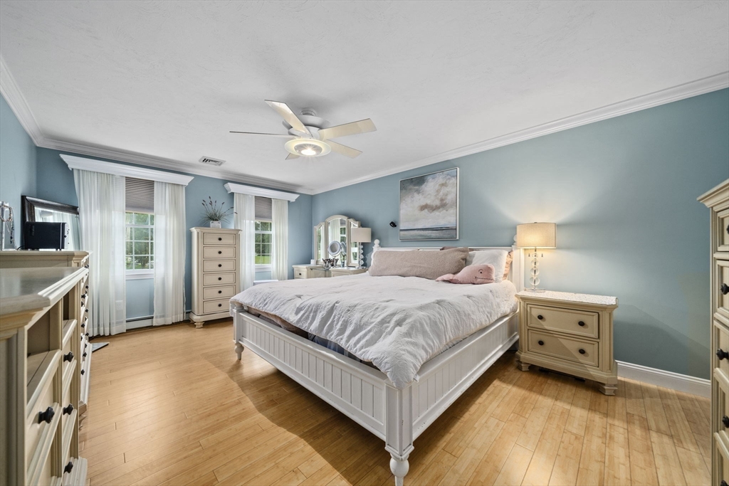 36 Meadow Lane Hanson, MA 02341 - Photo 12 of 36 a spacious bedroom with a bed and a chandelier