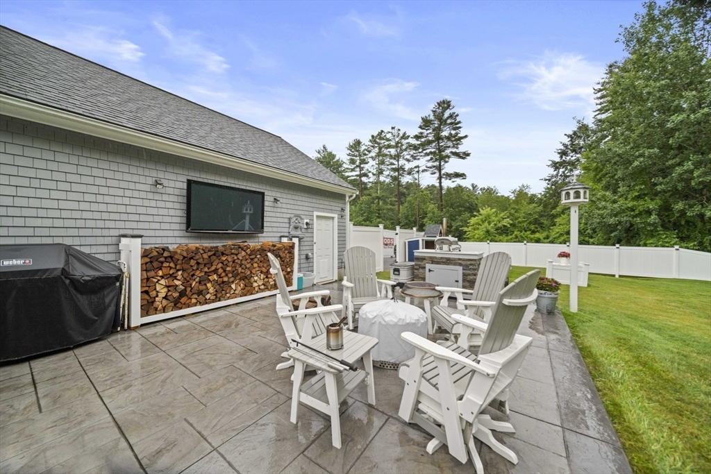 36 Meadow Lane Hanson, MA 02341 - Photo 25 of 36 a patio with table and chairs and potted plants