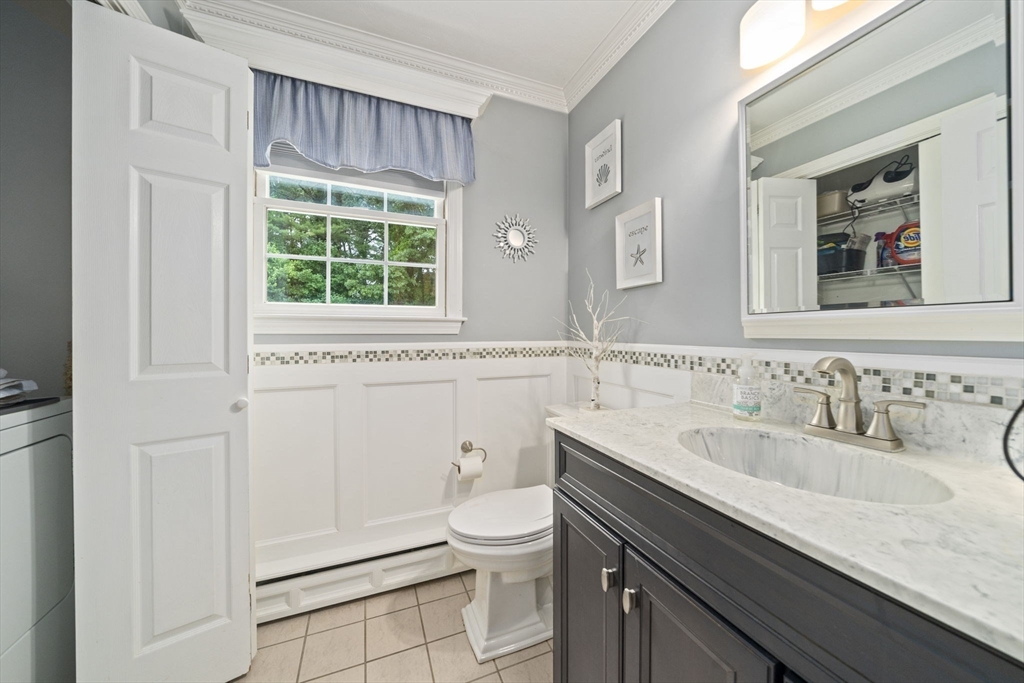36 Meadow Lane Hanson, MA 02341 - Photo 10 of 36 a bathroom with a granite countertop sink a toilet and a window
