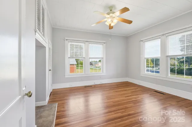 wooden floor in an empty room with a window