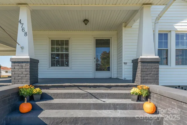 a front view of a house with outdoor seating