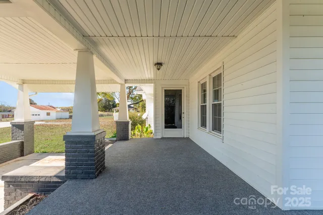 a view of a patio with wooden floor and iron stairs