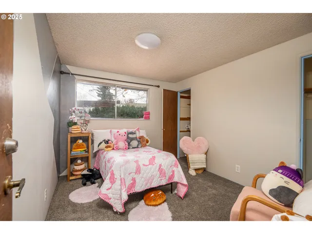 a bedroom with a bed and a large window
