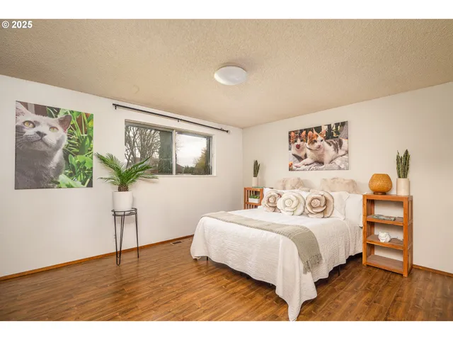 a bedroom with a bed and a potted plant