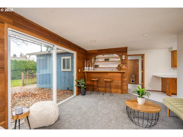 a living room with furniture and a floor to ceiling window