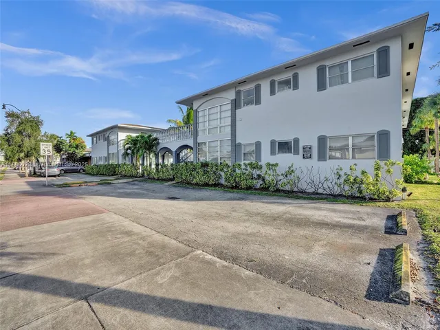 a front view of a house with a yard and a garage