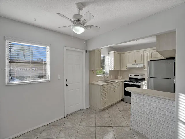 a kitchen with a sink stove and refrigerator