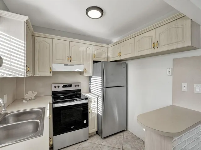 a kitchen with a refrigerator stove and sink