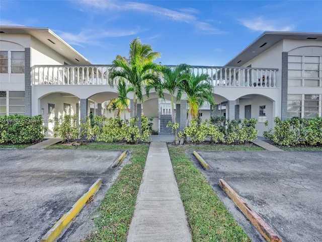 a view of a house with a yard and plants