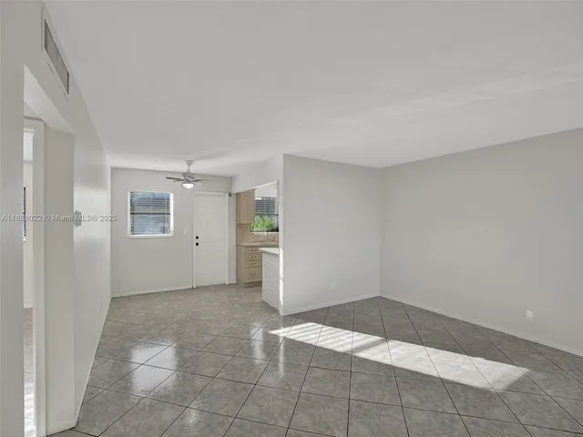 a view of an empty room and fire place