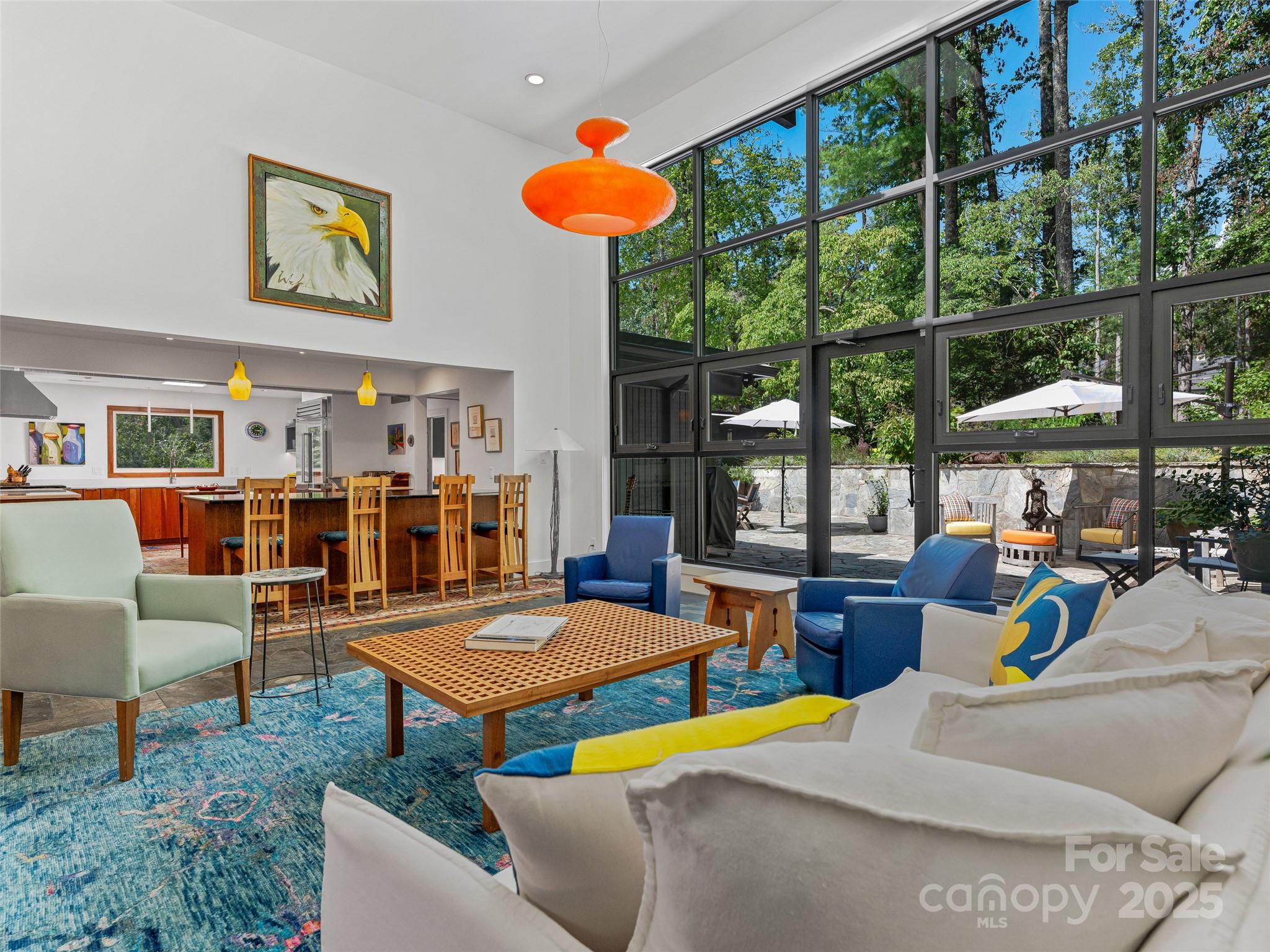5 Brookside Road Asheville, NC 28803 - Photo 16 of 45 a living room with furniture a fireplace and large windows